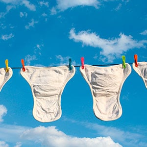 washed cloth diapers hanging on a line