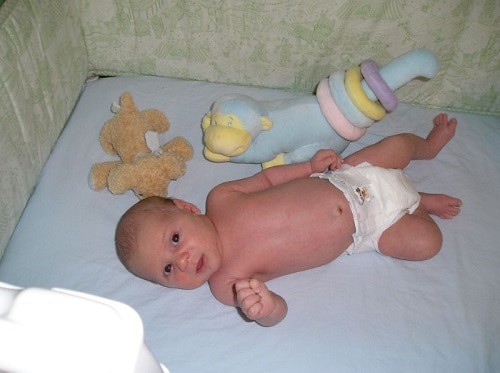 Baby lying inside the foam crib