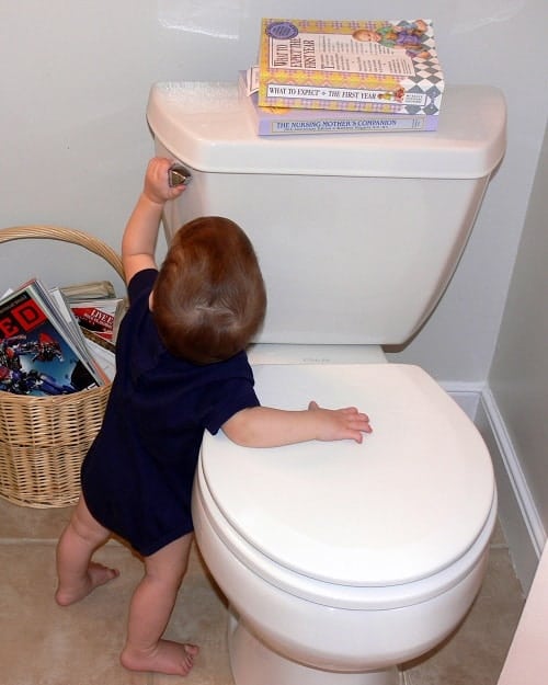 baby in toilet trying to flush