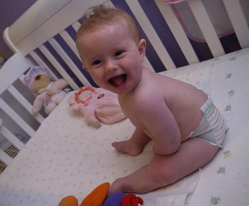 baby sitting in crib