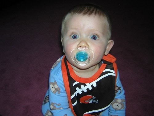 baby with black bib