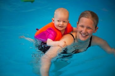 boy wearing swim vest