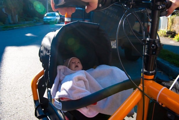 At what age can my baby ride in a baby trailer for bicycles