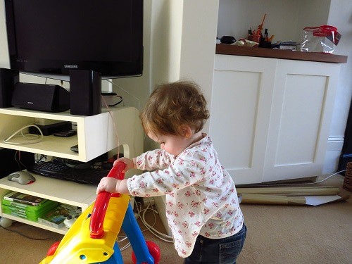 baby girl balancing her stand