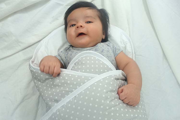 Baby Boy swaddled in bundlebee baby wrap