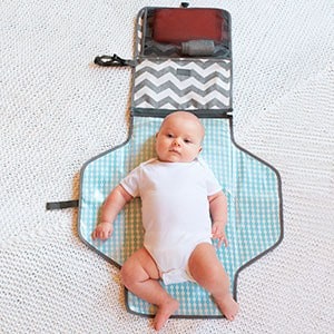 baby laying on diaper changing kit