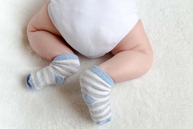 Baby wearing overnight diaper close up on bottom