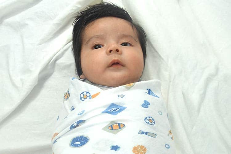 Baby wrapped in summer infant swaddleme muslin blanket