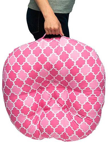 Boppy infant lounger carried by mom using handle