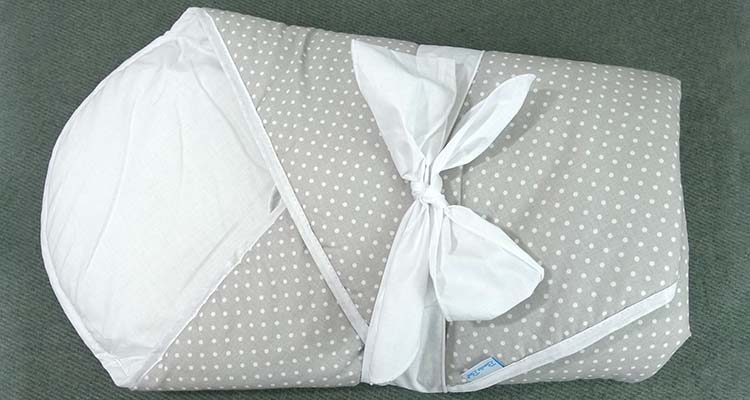 Bundlebee baby wrap with bow tied around the front