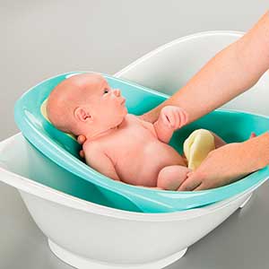 baby being washed in convertible baby bath tub