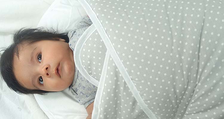 Cool and relaxed baby boy in bundlebee baby wrap swaddle
