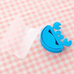 faucet rubber and plastic spout sitting on a checkered table cloth