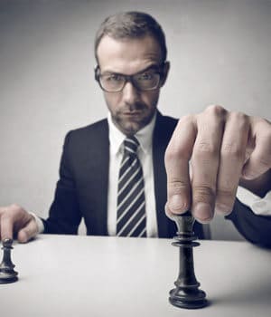 man holding chess piece