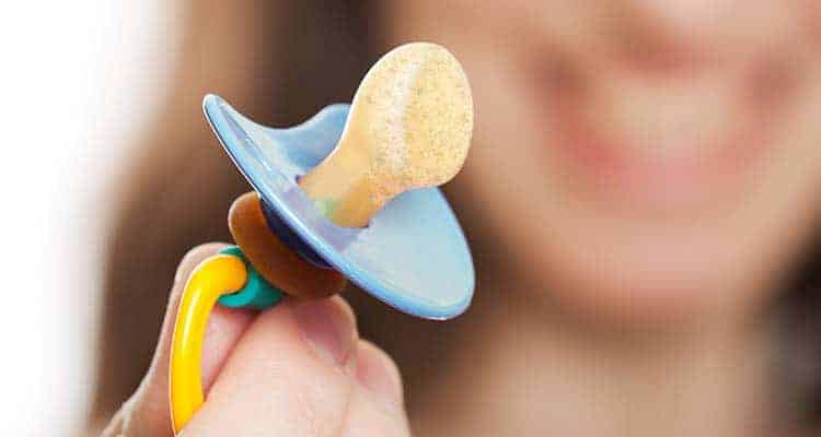 Pacifier covered in dirt and grime from falling onto the floor