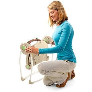 \portable baby swing being folded down into storage