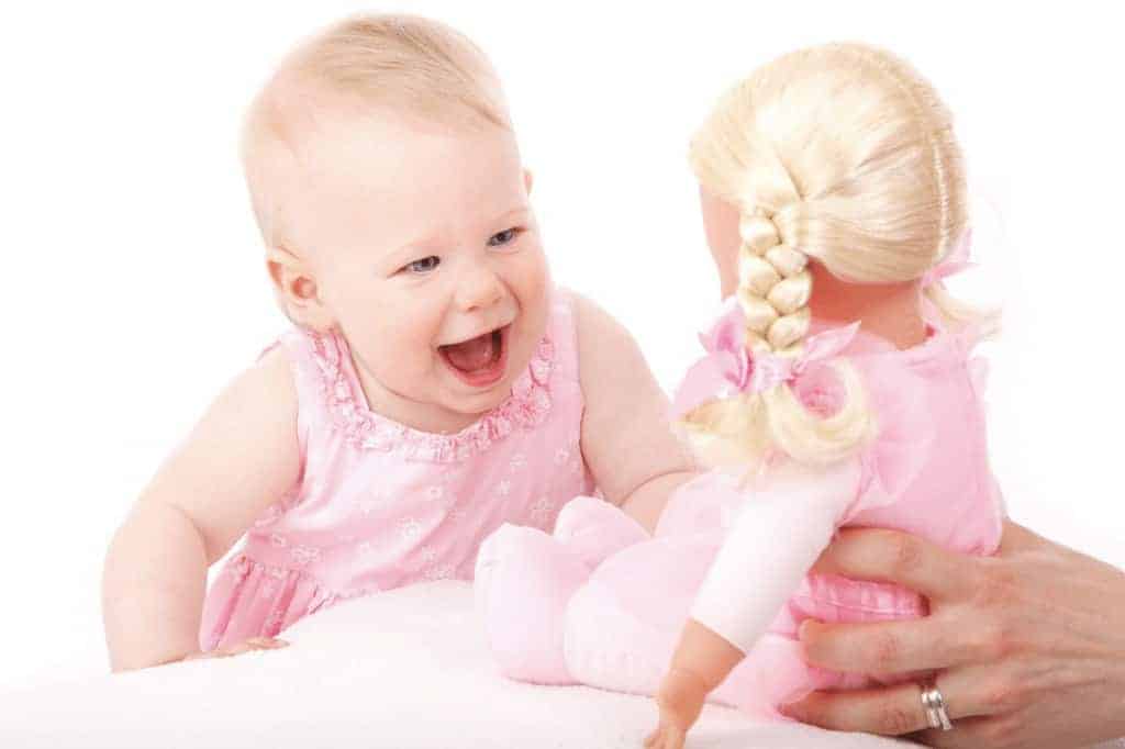 happy baby seeing the doll