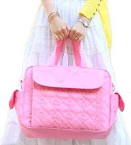 two hands holding a tote diaper bag