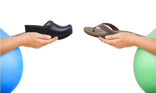 two pregnant women holding comfortable shoes