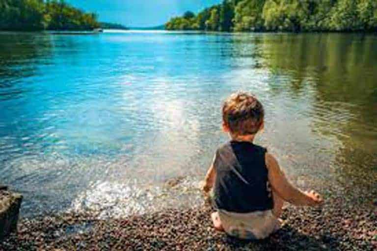 kid playing in the lake
