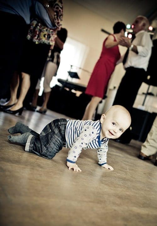 baby crawling while smiling