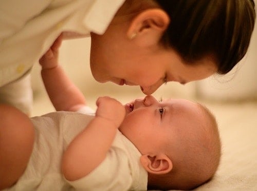 baby getting diaper changed on a changing pad