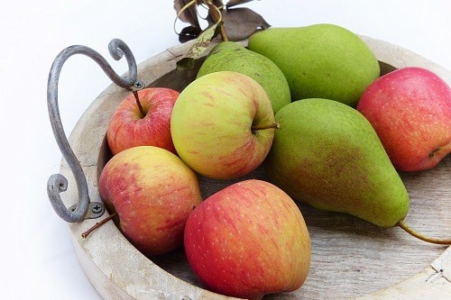 Pears amd apple on the brown tray wood