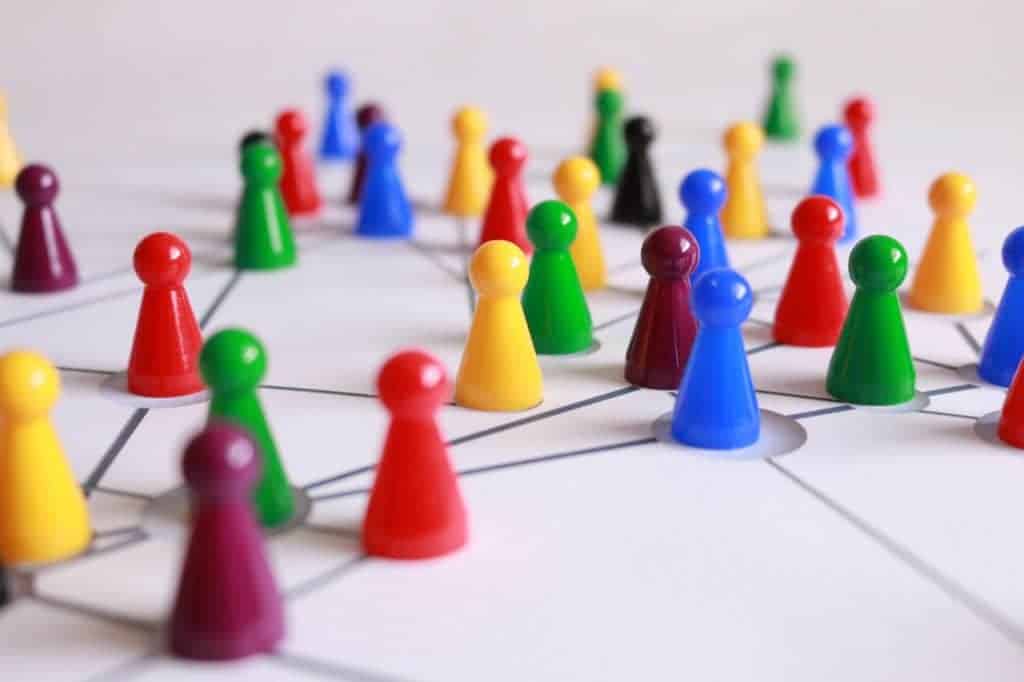 Yellow green red and brown plastic cones on white lined surface