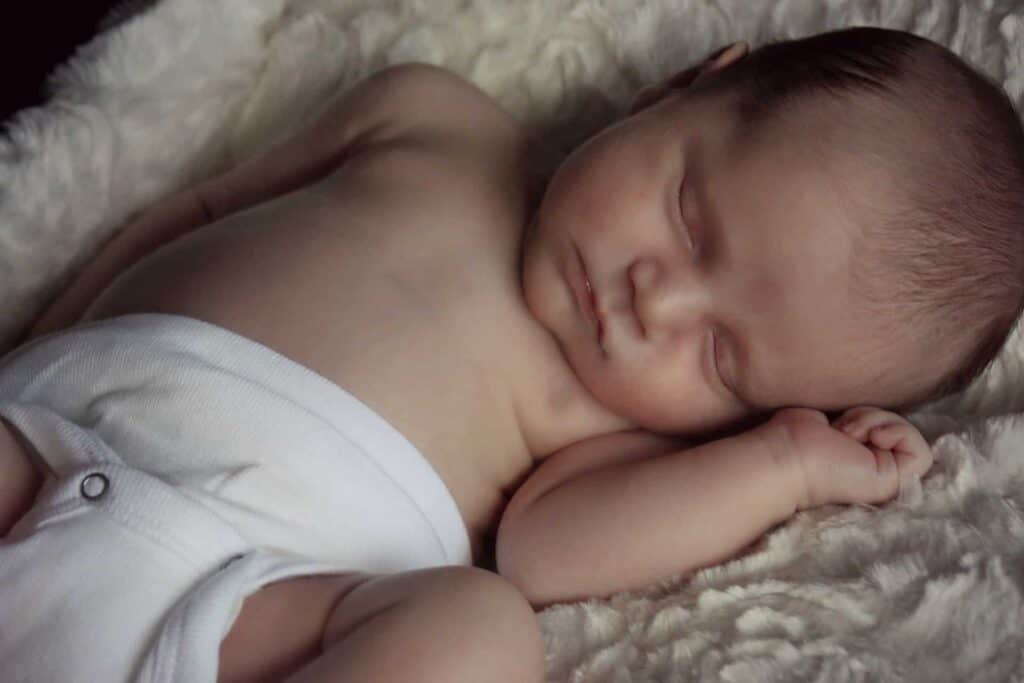 A sleeping baby that needs a Snuggle me organic lounger