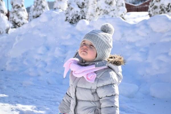 Child in snow wearing coat