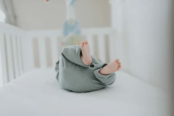 photo of baby wearing gray pants
