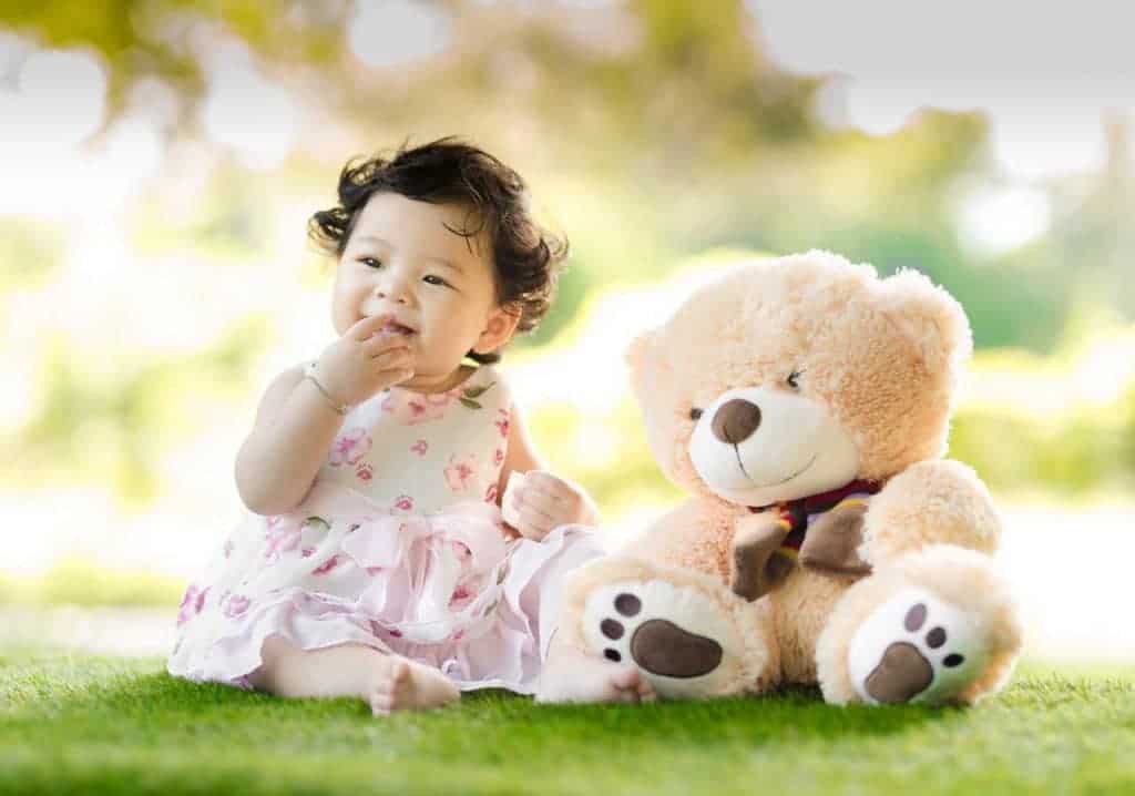 baby girl and a teddy bear