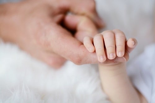 baby holding finger