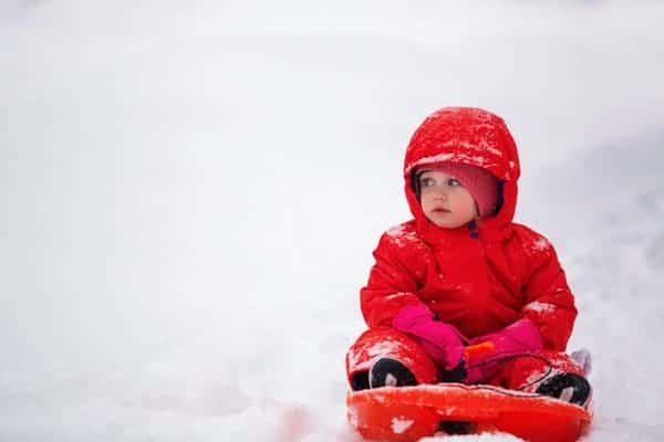 Child in red snowsuit