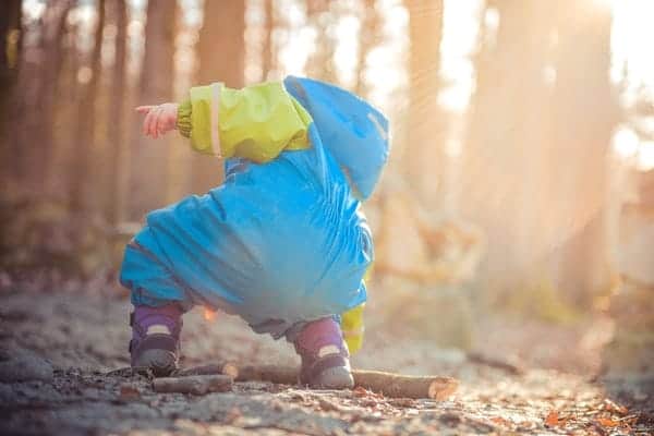 Child wearing Blue-Green raincoat