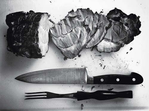 Grilled meat beside knife and fork