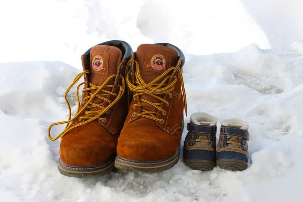 one of the best kids snow boots beside a pair of adult snow boots