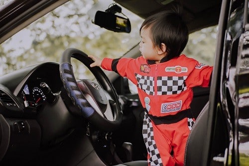 Baby standing inside the car