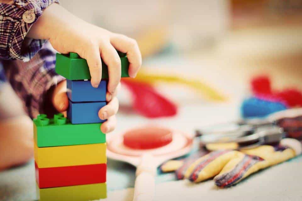 kid playing with building blocks