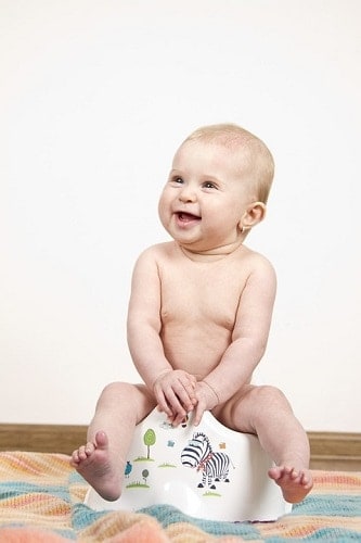 child sitting on potty
