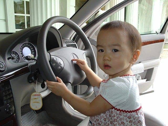 Baby inside a car wearing dress