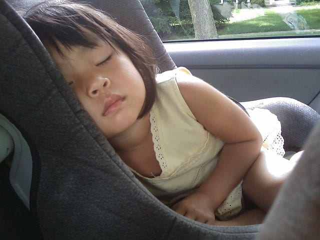 kid sleeping in car seat