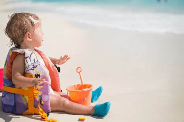 child wearing water shoes at the beach