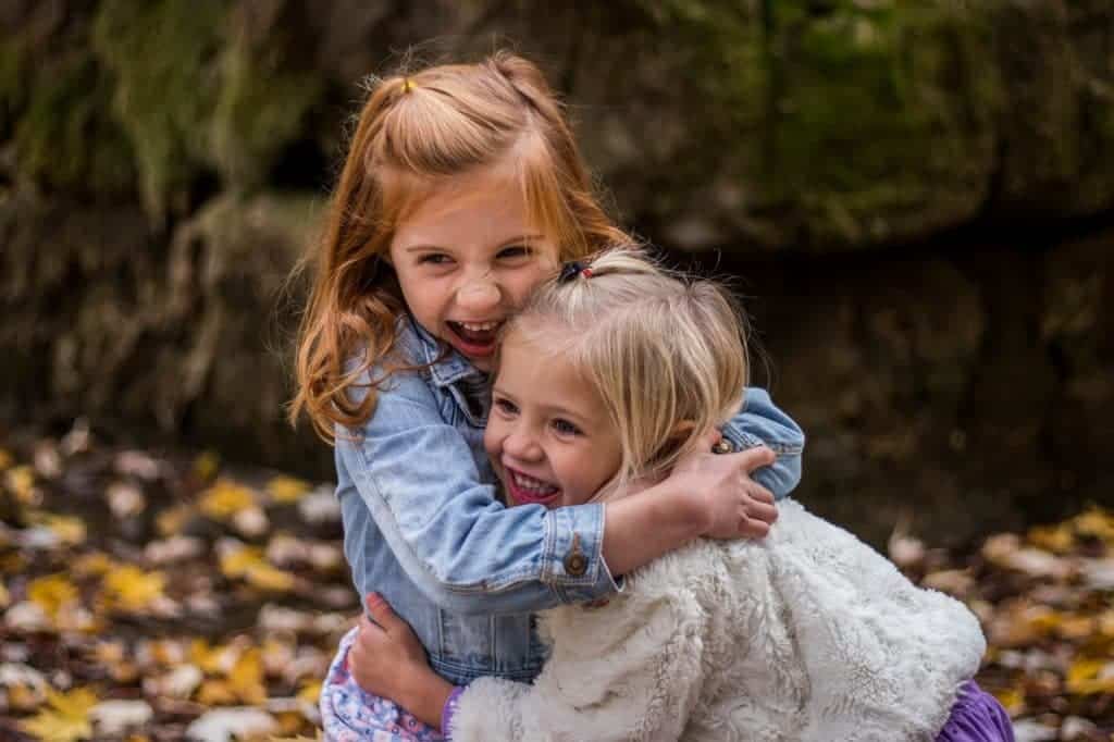 Two little girls hugging each other