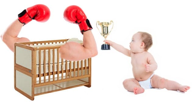 crib with arms held high while baby awards trophy