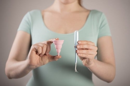 woman holding menstrual cup
