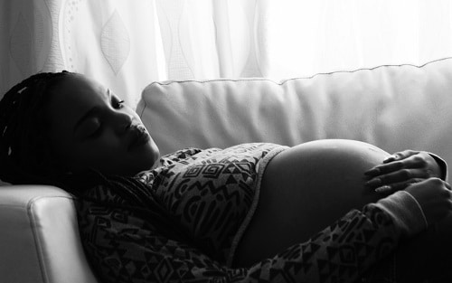 Pregnant woman lying on the sofa