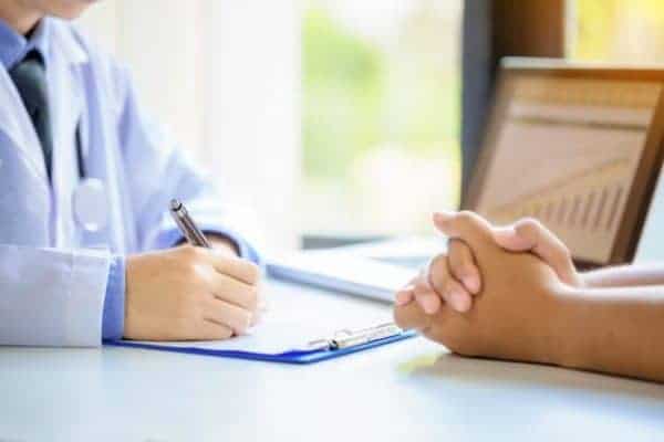 doctor prescribing folic acid supplement