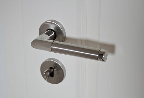 white door and key on hole