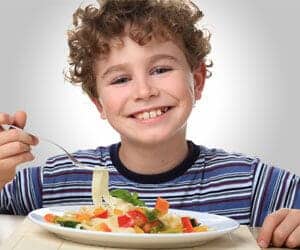 boy eating pasta